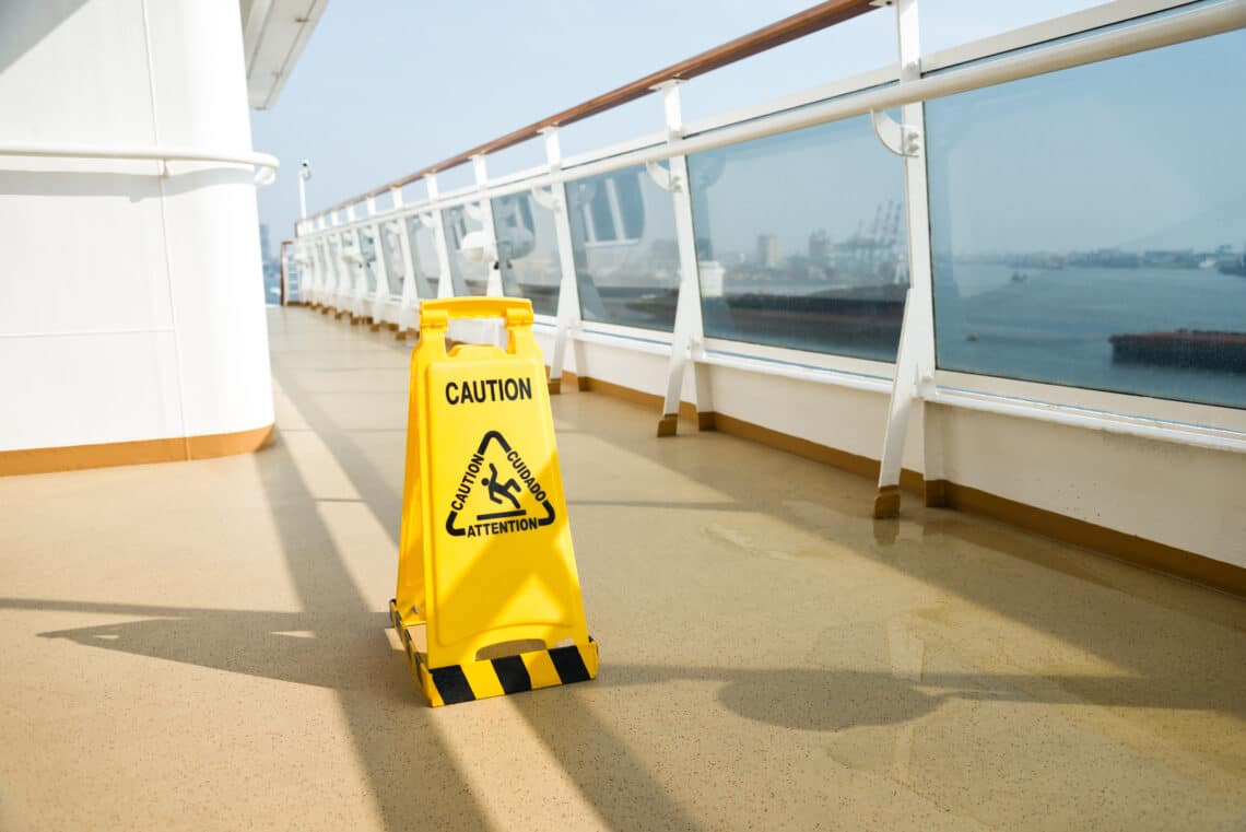 Wet floor sign on deck of cruise ship