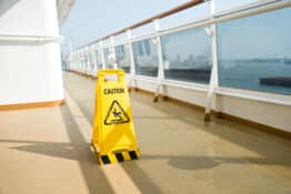 Wet floor sign on deck of cruise ship