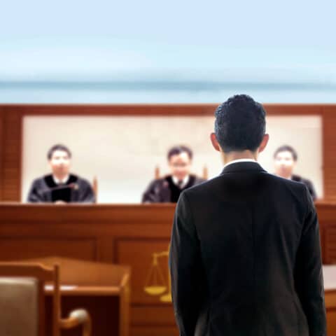 attorney litigating in front of judges